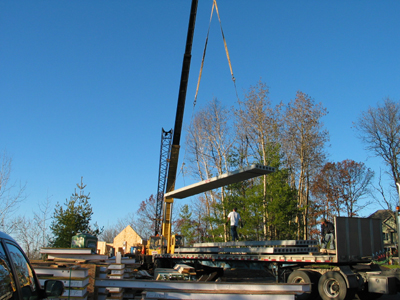 The crane lifts planks unto the roof deck