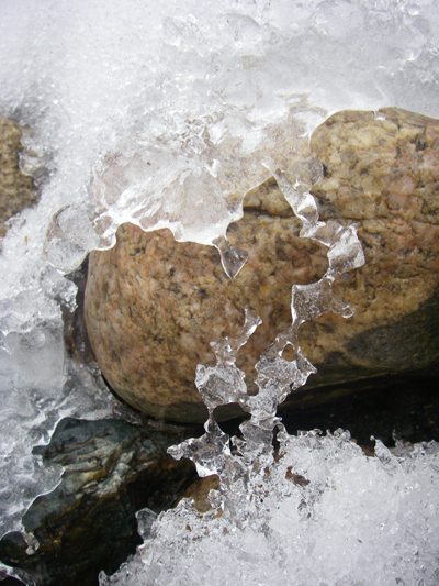 Rain falling on snowy rocks Rain falling on snowy rocks
