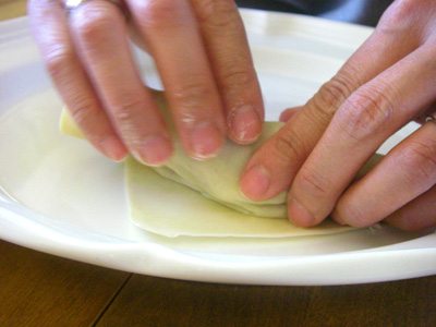 Step Three - Roll the eggroll toward the bottom point. Step Three - Roll the eggroll toward the bottom point.